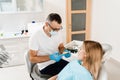 Dentist showing cast of teeth of patient woman before dental implantation. Procedure of creating dental prostheses Royalty Free Stock Photo