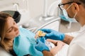 Dentist showing cast of teeth of patient woman before dental implantation. Procedure of creating dental prostheses Royalty Free Stock Photo