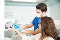 Dentist Showing Dental Xray To Female Patient In Clinic