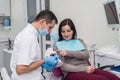 Dentist showing how to clean teeth right to patient Royalty Free Stock Photo