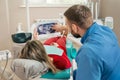 Dentist showing patient his X-ray teeth image Royalty Free Stock Photo