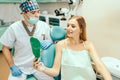 Dentist showing result of treatment for the patient. Royalty Free Stock Photo