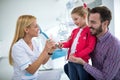 Dentist shows girl and her daddy`s jaw with teeth