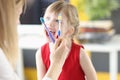 Dentist shows little girl toothbrushes and correct movements for oral care Royalty Free Stock Photo