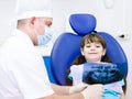 Dentist shows a patient x-ray of teeth