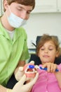 Dentist shows to patient girl how to brush teeth Royalty Free Stock Photo