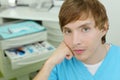 Dentist sits in cabinet of dental clinic