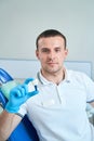 Dentist sitting in his office before tooth implantation procedure