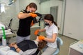 Dentist with special camera making professional shots of patient`s mouth after long treatment