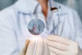 A dentist stomatologist shows a snapshot of a diseased tooth