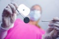 Dentist in surgical mask holding tools over patient Royalty Free Stock Photo