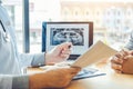 Dentist talking to male patient and presenting results on Dental x-ray film About the problem of the patient in dental office Royalty Free Stock Photo