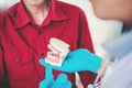 Dentist talking to smiling male patient and showing denture in dental office Royalty Free Stock Photo