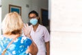 Dentist talks to his elderly patient at the entrance to the dental office - concept of wellness and prevention