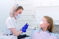 Dentist talks with woman patient on preventive examination stomatology clinic.