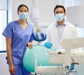 Dentist team, face mask and professional portrait for.medical industry and teamwork. Assistant woman and asian man or Royalty Free Stock Photo