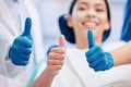 Dentist, thumbs up and happy patient in consultation for teeth whitening, service and dental care. Healthcare, dentistry