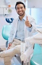 Dentist, thumbs up and portrait of man in office for teeth whitening, service and dental care. Healthcare, dentistry and