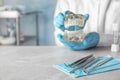 Dentist tools and blurred doctor with typodont teeth at table Royalty Free Stock Photo