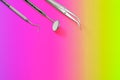 Dentist tools: mirror, dental probe and tweezers on purple green gradient background