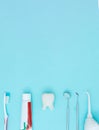 Dentist tools toothbrush, toothpaste and Tooth model on Blue background.. Dental equipment. Dental Care conceptual image Royalty Free Stock Photo