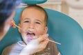 Dentist is treating a boy& x27;s teeth.Children& x27;s dentistry, Pediatric Dentistry. A female stomatologist is treating teeth of