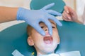 Dentist is treating a boy& x27;s teeth.Children& x27;s dentistry, Pediatric Dentistry. A female stomatologist is treating teeth of