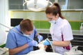 Dentist treating a patient`s teeth with dental tools in dental clinic. Dentistry.