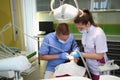 Dentist treating a patient`s teeth with dental tools in dental clinic. Dentistry. Royalty Free Stock Photo