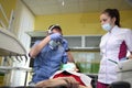 Dentist treating a patient`s teeth with dental tools in dental clinic. Dentistry.