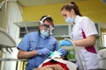 Dentist treating a patient`s teeth with dental tools in dental clinic. Dentistry. Royalty Free Stock Photo