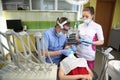 Dentist treating a patient`s teeth with dental tools in dental clinic. Dentistry. Royalty Free Stock Photo