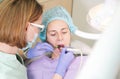 Dentist treats teeth in a dental clinic.