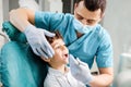 Dentist treats teeth of a teenager in a dental clinic