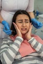 Dentist use dental tools for oral check up and examining cavities and gum at her female client Royalty Free Stock Photo