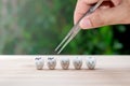 Dentist use tweezers to set of decayed tooth model for dental health care concept