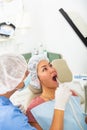 Dentist uses modern equipment and a computer to check patient teeth