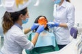 Dentist using curing light. Royalty Free Stock Photo