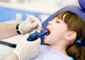 Dentist using dental filling gun on kid