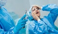 Dentist using surgical pliers to remove a decaying tooth.