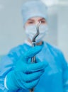 Dentist using surgical pliers to remove a decaying tooth.