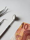 dentist utensils for oral review and european banknote of ten euro