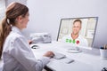 Dentist Video Conferencing With Man On Computer Royalty Free Stock Photo