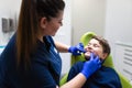 Dentist visually assesses the condition of the teenager`s teeth. Boy at the dentist. Royalty Free Stock Photo