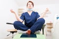 Dentist woman meditating with yoga and lotus position Royalty Free Stock Photo