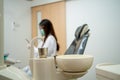 Dentist woman prepare tools for treatment in dental clinic as background with main focus on glass of water for gargle Royalty Free Stock Photo