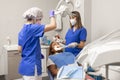 The dentist woman adjust the dental operating light at the dental clinic