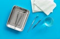 Dentist work desk with tools for teeth on blue background top view Royalty Free Stock Photo