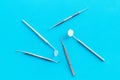 Dentist work desk with tools for teeth on blue background top view Royalty Free Stock Photo