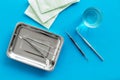 Dentist work desk with tools for teeth on blue background top view Royalty Free Stock Photo